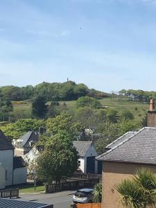 a town with houses and a hill in the background at Kennedy Terrace; Modern 2 bedroom house, central in Stornoway