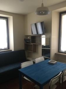 a living room with a blue table and a tv at VICOLOVOLTA16 in Torri del Benaco