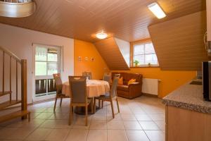 a kitchen and dining room with a table and chairs at Riehle Hof in Zell am Harmersbach