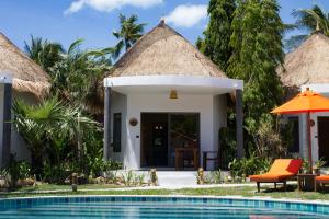 a villa with a swimming pool and a resort at Secret Garden Beach Resort in Bangrak Beach