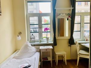 a bedroom with a bed and a window at Pension Karina Schwerin in Schwerin
