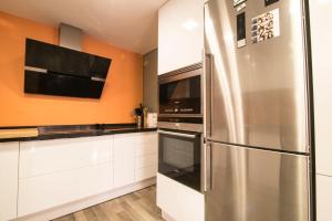 a kitchen with a stainless steel refrigerator and a microwave at Céntrico y actualizado con estilo in Valencia