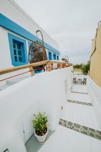 a balcony with a blue and white building at Pueblo Viejo Suites in Kamari