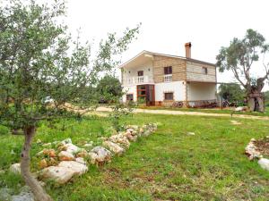 a house with a yard with rocks in front of it at Gio Horses B&B in Sannicandro Garganico