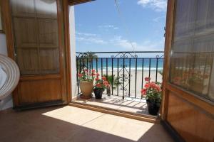 an open door with potted plants on a balcony at AR3B, Arsenal Barry, en primera línea in Villajoyosa