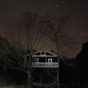 a house under a starry sky at night at Blini-Park Guesthouse in Mollʼ e Shoshit