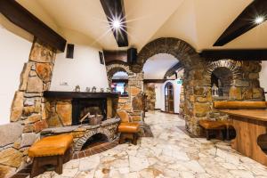 a stone fireplace in a room with a stone wall at Ośrodek Wypoczynkowy Tarnica in Solina