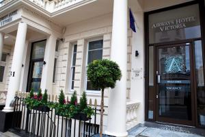 a store front of a building with columns and flowers at The 29 London in London