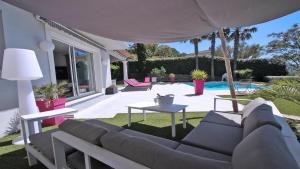 a living room with a couch and a table at Villa Jade in Sainte-Maxime