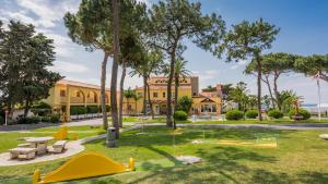 a park with playground equipment in front of a building at Macdonald Leila Playa Resort in La Cala de Mijas