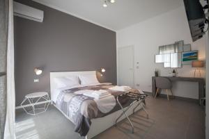 Ένα ή περισσότερα κρεβάτια σε δωμάτιο στο Prometeo rooms