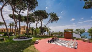 a chess board on a red carpet in a park at Macdonald Leila Playa Resort in La Cala de Mijas
