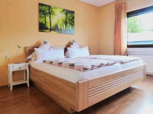 a large bed in a room with a window at Ferienwohnungen Bach in Bernkastel-Kues