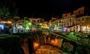 a view of a city at night with lights at La Torre del Mulino - SUPERIOR Rooms in Tropea