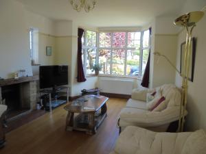 a living room with two couches and a tv at Kelvin Side in Eastbourne