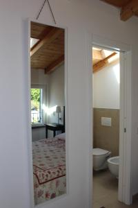 a door leading to a bedroom with a bed and a bathroom at Le Caravelle in Levanto