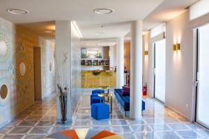 a lobby with a blue couch and blue chairs at Grand Hotel Miramare in Taormina