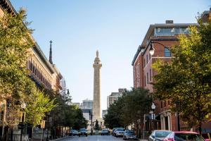 a tall clock tower towering over a city street at Hotel Revival Baltimore, part of JdV by Hyatt in Baltimore