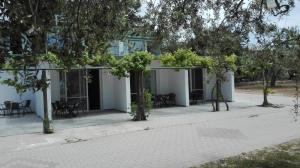 a white building with trees in front of it at Bluegreen Studios in Pefkari