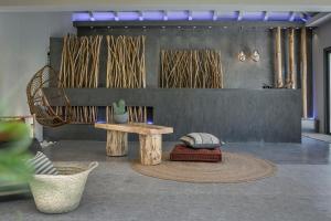 a room with a table and a bench and a chair at Avithos Resort Hotel in Svoronata