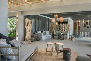 a living room with a couch and chairs and tables at Avithos Resort Hotel in Svoronata
