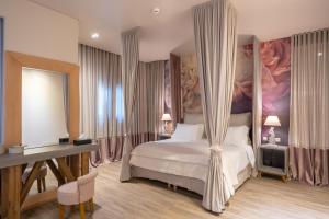 1 dormitorio con 1 cama con dosel en Mikelina Boutique Hotel, en Pallini
