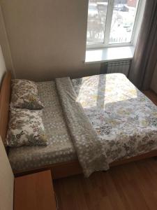 a bedroom with a bed and a window at Apartments on Kirova in Dnipro