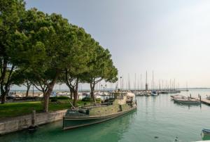 a boat is docked in the water at a marina at Atico Hotel in Desenzano del Garda