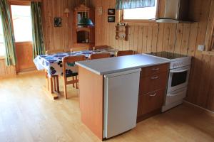 a kitchen with a table and a stove top oven at Nordkapp Camping in Honningsvåg