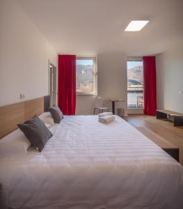 a hotel room with two beds and a large window at La Villa - Luxury Guest House in Trento