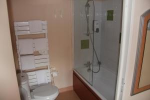a bathroom with a toilet and a shower with towels at Logis Hôtel de France restaurant le Lucullus in Montmorillon +33 photos