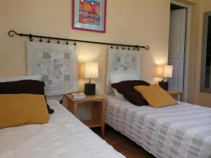 two beds sitting next to each other in a room at Montloubier in Villeneuve-de-Berg