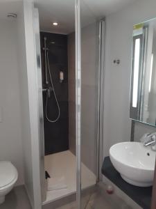 a bathroom with a shower and a toilet and a sink at Les Embruns in Trouville-sur-Mer