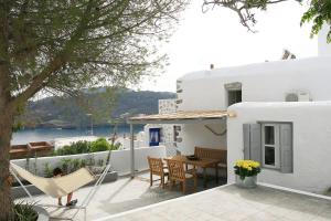 a patio with a hammock and a table and chairs at The Pulse Residence Astypalea in Astypalaia