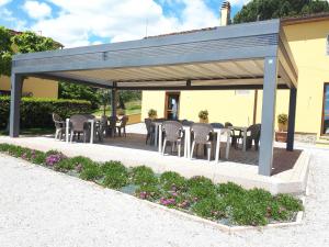 a pavilion with tables and chairs and flowers at Agriturismo Villa Bracali in Serravalle Pistoiese