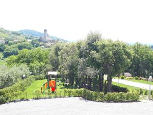 a park with a playground with a slide and trees at Agriturismo Villa Bracali in Serravalle Pistoiese