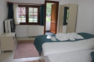 a bedroom with a bed with towels on it at Uzungol Selale otel Bungalow in Uzungöl