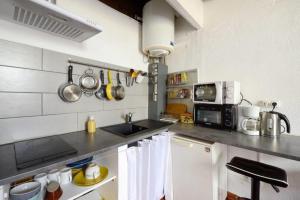 a kitchen with a sink and a counter top at Appartement le Platane in Pertuis