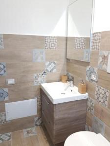 a bathroom with a sink and a toilet and a mirror at Al Bosco Ficuzza in Ficuzza +35 photos