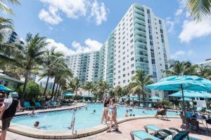 a pool at a resort with people in it at Miami Hollywood Bay View on the Beach in Hollywood