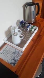 a tray with a coffee pot on a wooden table at Valhalla B&B in Bowermadden