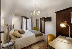 a bedroom with a bed and a lamp at Itria Palace in Ragusa