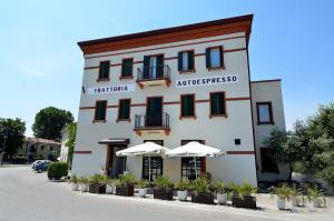 a building with two umbrellas in front of it at Hotel Autoespresso Venice - Atika & Atif in Marghera
