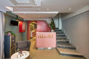 a lobby with stairs and a pink wall with the word wildlife at Nika otel & cafe in Istanbul