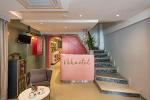 a lobby with stairs and a sign that reads wilted at Nika otel & cafe in Istanbul
