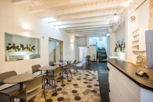 a restaurant with tables and chairs in a room at Aras Hotel Boutique in Villasimius