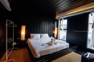 a bedroom with a bed with a stuffed animal on it at Trat 101 Hotel - SHA Certified in Trat