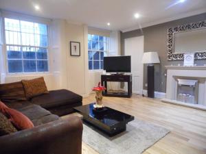 a living room with a couch and a fireplace at WEST END -Stunning, 2 bedroom, main door flat with private parking in Glasgow