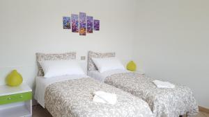 due letti uno accanto all'altro in una camera da letto di Terrazza Zèfiro Casa vacanze a Matera