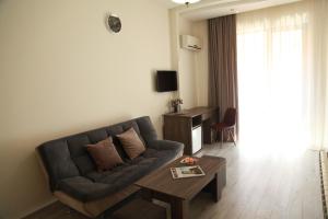 a living room with a couch and a coffee table at Rio in Tbilisi City